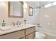 Clean bathroom featuring a bathtub/shower combination, stylish mirror and vanity at 389 Mill Creek Ne Bnd, Atlanta, GA 30307