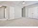 Spacious bedroom featuring neutral carpet, a ceiling fan, and closet space at 389 Mill Creek Ne Bnd, Atlanta, GA 30307