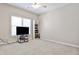 Spacious bedroom with television, bookshelf and neutral walls create a cozy and versatile space at 389 Mill Creek Ne Bnd, Atlanta, GA 30307