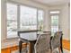 Bright dining area with a dark table, woven chairs, bench seating, and large windows at 389 Mill Creek Ne Bnd, Atlanta, GA 30307