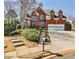 Inviting two-story brick home with well-kept landscaping, featuring a convenient two-car garage at 389 Mill Creek Ne Bnd, Atlanta, GA 30307