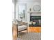 Close-up of the fireplace with hardwood floors and a chair and a round mirror above at 389 Mill Creek Ne Bnd, Atlanta, GA 30307