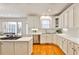Bright, modern kitchen featuring white cabinets, stainless steel appliances, and hardwood flooring at 389 Mill Creek Ne Bnd, Atlanta, GA 30307