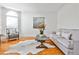 Bright living room featuring hardwood floors, a cozy sofa, and a large arched window at 389 Mill Creek Ne Bnd, Atlanta, GA 30307