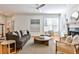 Bright living room featuring hardwood floors, modern fan, and a decorative fireplace at 389 Mill Creek Ne Bnd, Atlanta, GA 30307