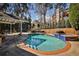 Backyard pool with sparkling water, brick trim, stairs, and landscaping with mature trees offer a tranquil setting at 389 Mill Creek Ne Bnd, Atlanta, GA 30307