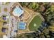 Aerial view of the community pool, playground, tennis courts, and pond at 529 Azalea Bloom Dr, Loganville, GA 30052
