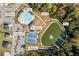 Aerial view of community amenities, including the pool, clubhouse, tennis court, and pond at 529 Azalea Bloom Dr, Loganville, GA 30052