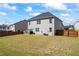 Wide backyard featuring a manicured lawn, with a fence and patio at 529 Azalea Bloom Dr, Loganville, GA 30052