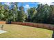 Large backyard with wooden fence, grassy lawn and trees, great for outdoor fun at 529 Azalea Bloom Dr, Loganville, GA 30052