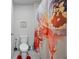 Cozy bathroom featuring a toilet, a colorful shower curtain, and decor at 529 Azalea Bloom Dr, Loganville, GA 30052