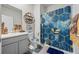 Bathroom with a modern vanity, toilet, and a shower with a blue and gold decorative curtain at 529 Azalea Bloom Dr, Loganville, GA 30052