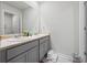 Bathroom with double sink, neutral countertop, gray cabinets, and large mirror at 529 Azalea Bloom Dr, Loganville, GA 30052