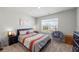 Bedroom with window, carpet, accent chair, and queen bed with decorative pillows at 529 Azalea Bloom Dr, Loganville, GA 30052
