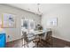 Dining room features table with gold accents, modern chandelier and view to the exterior at 529 Azalea Bloom Dr, Loganville, GA 30052