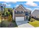 Charming two-story home with a brick facade, well-maintained landscaping, and a two-car garage at 529 Azalea Bloom Dr, Loganville, GA 30052