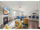Open-concept living room and kitchen with fireplace, TV, modern furniture, and bar seating at 529 Azalea Bloom Dr, Loganville, GA 30052
