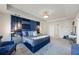 Spacious main bedroom with tray ceiling, accent wall, lamps, sitting area, vanity, and carpet at 529 Azalea Bloom Dr, Loganville, GA 30052