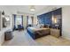 Beautiful main bedroom with tray ceiling, accent wall, lamps, and carpet at 529 Azalea Bloom Dr, Loganville, GA 30052