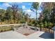 Outdoor kitchen with stone fireplace, grill, cooking space, and surrounding mature trees at 529 Azalea Bloom Dr, Loganville, GA 30052