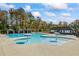 Community pool area featuring a large pool, splash pads, and covered lounge areas at 529 Azalea Bloom Dr, Loganville, GA 30052