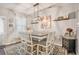 Bright dining area with stylish lighting, seating for six, and easy access to the kitchen at 6454 Grey Fox Way, Riverdale, GA 30296