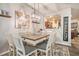 Elegant dining space with decorative lighting, comfortable seating, and view to kitchen at 6454 Grey Fox Way, Riverdale, GA 30296