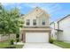 Charming home featuring a two-car garage and traditional architectural details at 6454 Grey Fox Way, Riverdale, GA 30296
