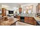 Traditional kitchen featuring wooden cabinets, granite countertops, island with seating, and stainless steel appliances at 6454 Grey Fox Way, Riverdale, GA 30296