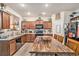 Traditional kitchen featuring wooden cabinets, granite countertops, island with seating, and stainless steel appliances at 6454 Grey Fox Way, Riverdale, GA 30296