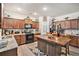 Traditional kitchen featuring wooden cabinets, granite countertops, island with seating, and stainless steel appliances at 6454 Grey Fox Way, Riverdale, GA 30296