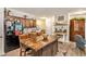 Traditional kitchen featuring wooden cabinets, granite countertops, island with seating, and stainless steel appliances at 6454 Grey Fox Way, Riverdale, GA 30296