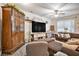 Cozy living room featuring a ceiling fan, decorative shelves and modern furnishings at 6454 Grey Fox Way, Riverdale, GA 30296