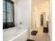 The bathroom showcases a soaking tub, a long vanity with wood cabinets, and a clear glass shower at 6454 Grey Fox Way, Riverdale, GA 30296