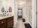 The bathroom showcases a soaking tub, a long vanity with wood cabinets, and a clear glass shower at 6454 Grey Fox Way, Riverdale, GA 30296