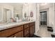 The bathroom showcases a soaking tub, a long vanity with wood cabinets, and a clear glass shower at 6454 Grey Fox Way, Riverdale, GA 30296