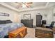 A cozy bedroom that features ample room, modern decor, ceiling fan and a large TV for entertainment at 6454 Grey Fox Way, Riverdale, GA 30296
