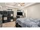 A cozy bedroom that features ample room, modern decor, ceiling fan and a large TV for entertainment at 6454 Grey Fox Way, Riverdale, GA 30296