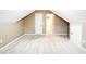 Attic room with neutral walls, carpet, and view to doorway, offers flexible living space at 1008 Walnut Creek Dr, Woodstock, GA 30188