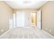 A bright bedroom with neutral walls, plush carpet, and a ceiling fan with white trim at 1008 Walnut Creek Dr, Woodstock, GA 30188