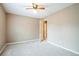 Inviting room features neutral walls, cozy gray carpet, ceiling fan, and open doorway at 1008 Walnut Creek Dr, Woodstock, GA 30188