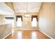 Open dining area with hardwood floors, high ceilings, elegant lighting, and large windows at 1008 Walnut Creek Dr, Woodstock, GA 30188