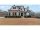 Charming two-story home with a combination of brick and vinyl siding and manicured landscaping at 1008 Walnut Creek Dr, Woodstock, GA 30188