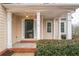 Welcoming front porch with classic columns, brick steps, and a dark front door at 1008 Walnut Creek Dr, Woodstock, GA 30188