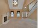 Spacious living room boasts high ceilings, fireplace, carpet, large windows, and a staircase at 1008 Walnut Creek Dr, Woodstock, GA 30188