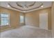 Large main bedroom with a decorative tray ceiling, recessed lights, and neutral carpet at 1008 Walnut Creek Dr, Woodstock, GA 30188