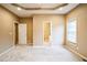 Spacious main bedroom with neutral carpet and a view into the adjoining bathroom at 1008 Walnut Creek Dr, Woodstock, GA 30188