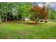 A spacious backyard with a shed and patio area surrounded by lush greenery at 1050 Chestnut Hill Sw Cir, Marietta, GA 30064