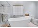 Bright bathroom with a free-standing soaking tub and modern fixtures at 1050 Chestnut Hill Sw Cir, Marietta, GA 30064