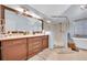 Bathroom featuring a glass-enclosed shower, soaking tub, dual vanity, and tiled floors at 1050 Chestnut Hill Sw Cir, Marietta, GA 30064